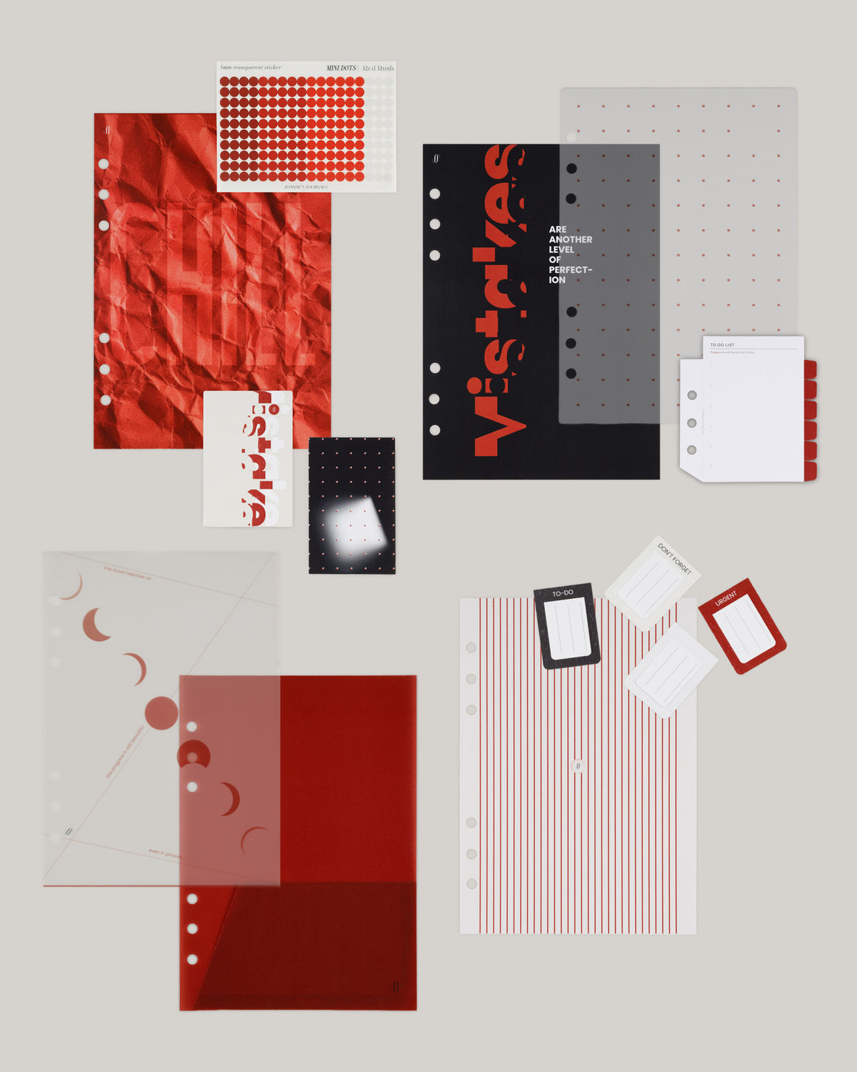 Edition 003 red stationery, dashboards, stickers and accessories laid out on a warm grey background